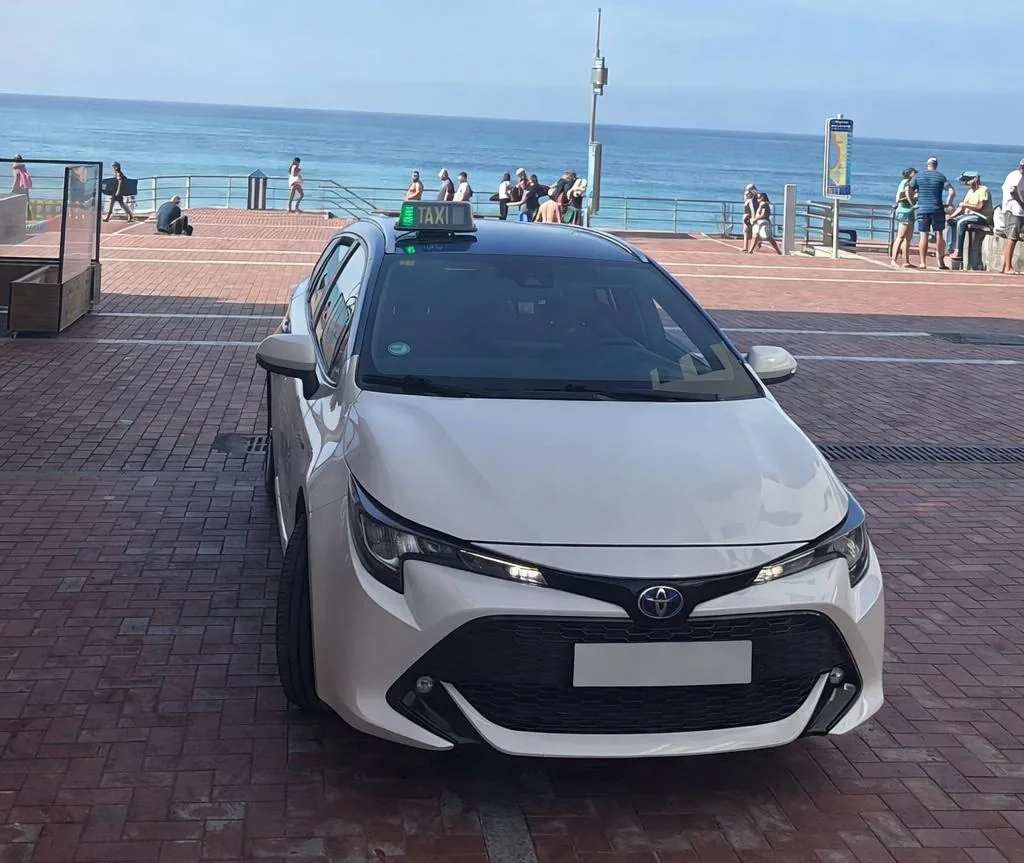 Front of the Toyota Corolla Touring with the green for-hire taxi light on