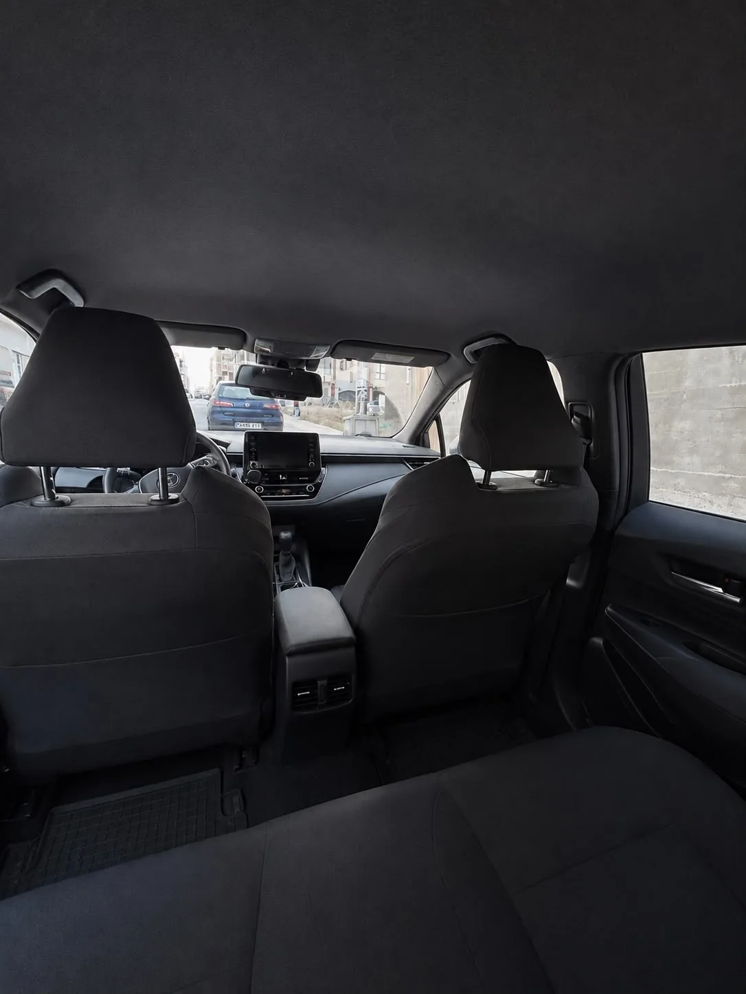 The rear seats of the car, clean and with room
